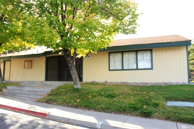 single story home featuring a front lawn