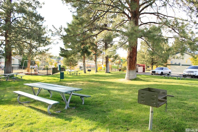 surrounding community with fence and a lawn