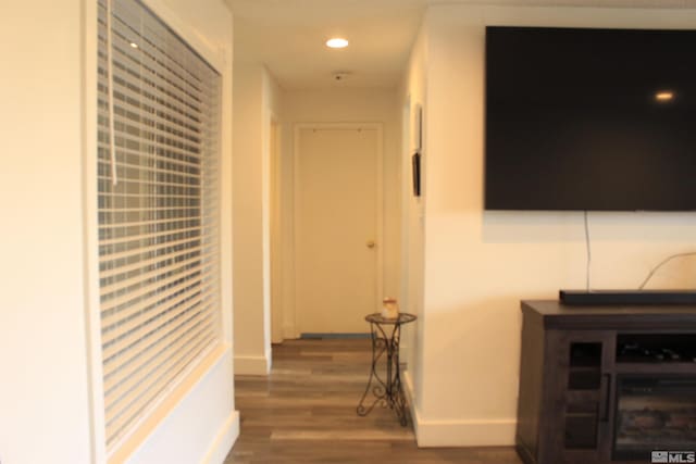 corridor featuring recessed lighting, wood finished floors, and baseboards