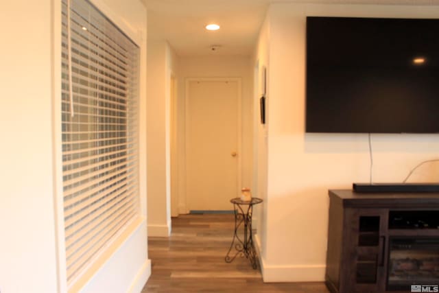 hallway with recessed lighting, wood finished floors, and baseboards