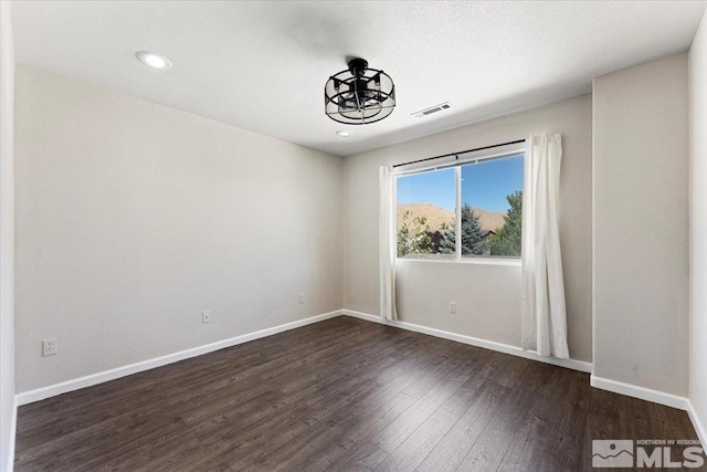 spare room featuring dark hardwood / wood-style floors