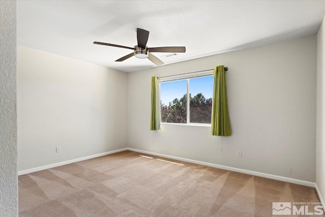 carpeted empty room with a ceiling fan, visible vents, and baseboards