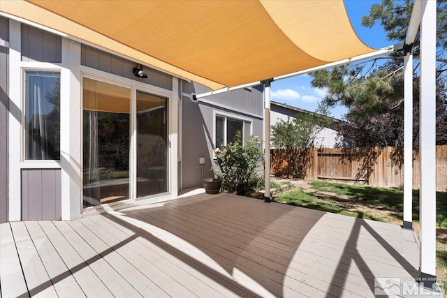 wooden terrace featuring fence