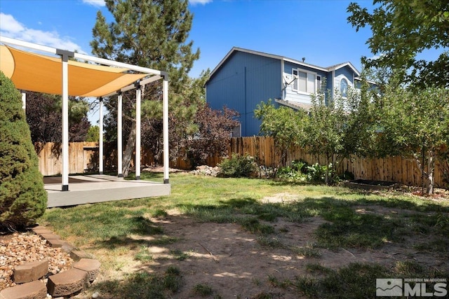 view of yard with fence and a patio