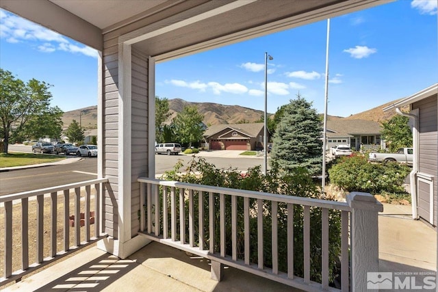 balcony with covered porch and a mountain view