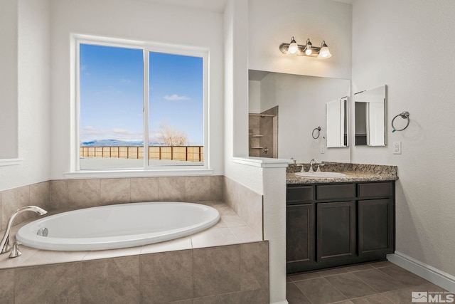 bathroom with vanity, tile patterned floors, and independent shower and bath