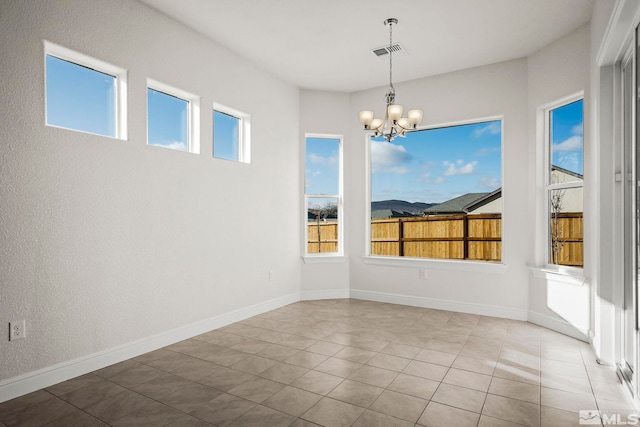 unfurnished dining area with light tile patterned floors, plenty of natural light, and a notable chandelier