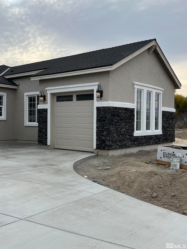 view of side of home featuring a garage