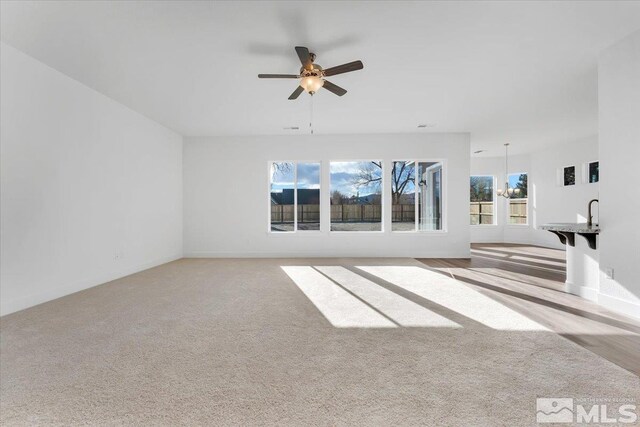 spare room with light colored carpet and ceiling fan