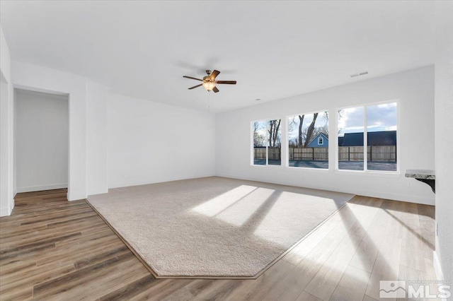 unfurnished living room with hardwood / wood-style flooring and ceiling fan