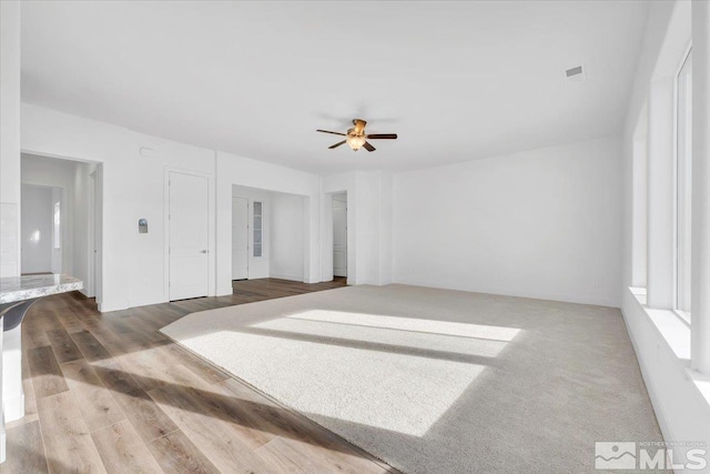 empty room featuring wood-type flooring and ceiling fan