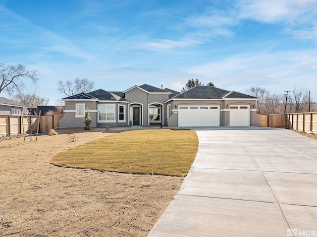 view of front of property with a garage, concrete driveway, fence, a front lawn, and stucco siding