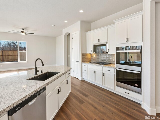 kitchen featuring gray cabinetry, backsplash, hardwood / wood-style floors, and appliances with stainless steel finishes