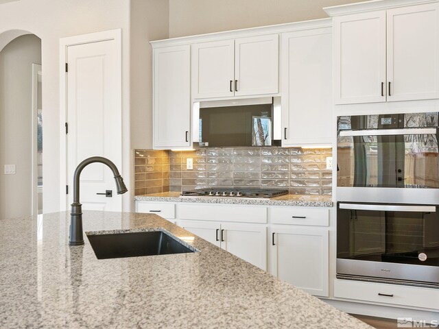 full bathroom featuring tile patterned floors, tiled shower / bath, vanity, and toilet