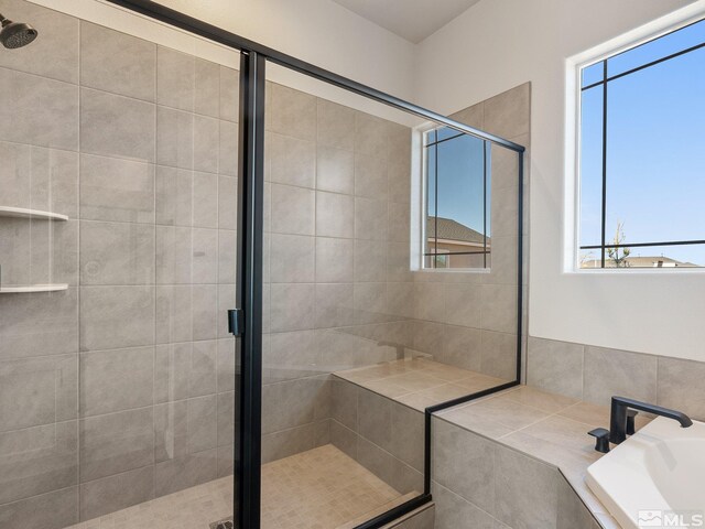 bathroom featuring vanity and tiled tub