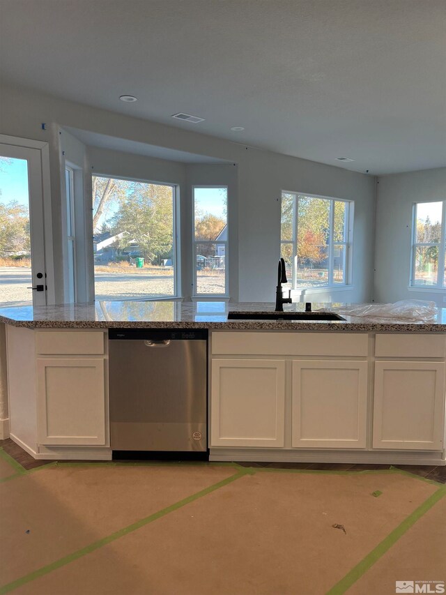 kitchen with white cabinetry, dishwasher, and sink