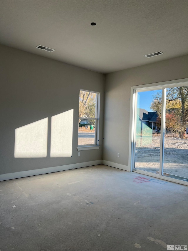 empty room featuring visible vents and baseboards