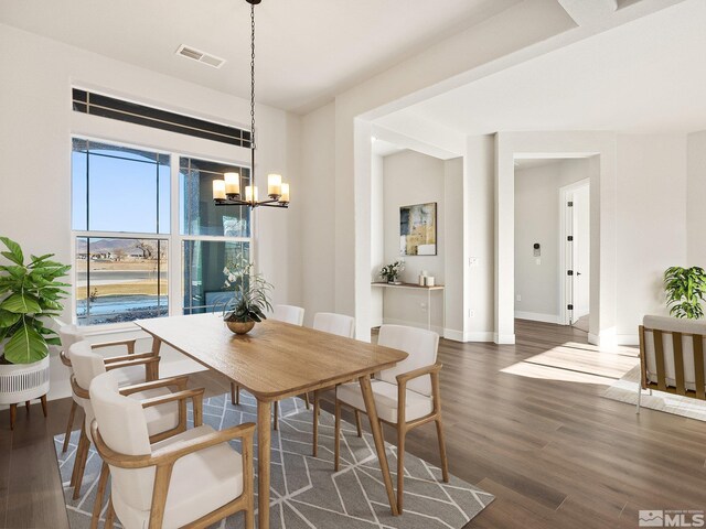 kitchen with dark hardwood / wood-style floors, a kitchen island, sink, and stainless steel appliances