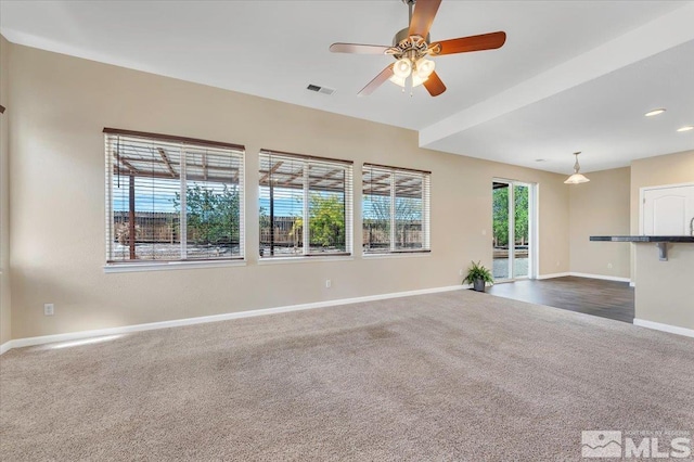 unfurnished living room featuring recessed lighting, a ceiling fan, visible vents, baseboards, and dark carpet