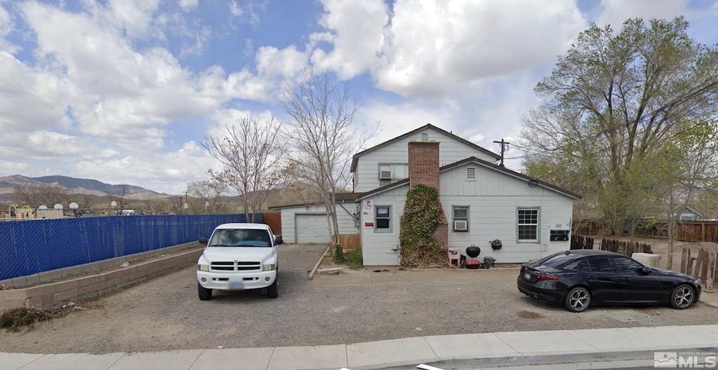 view of front of home with a garage and fence