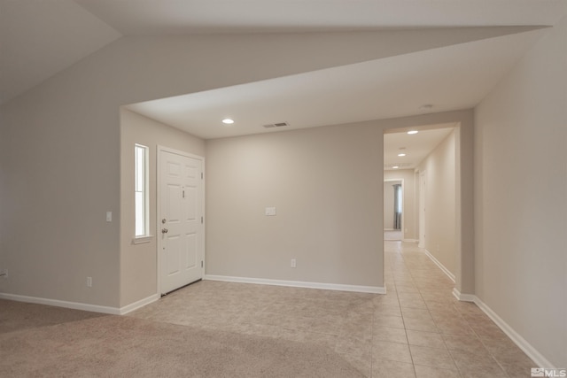 tiled foyer entrance featuring lofted ceiling