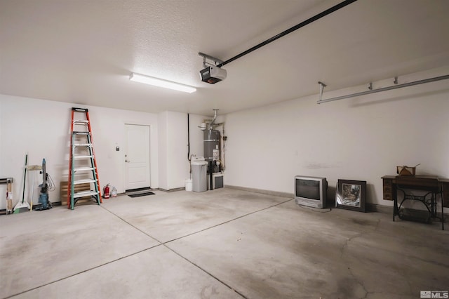 garage featuring strapped water heater and a garage door opener