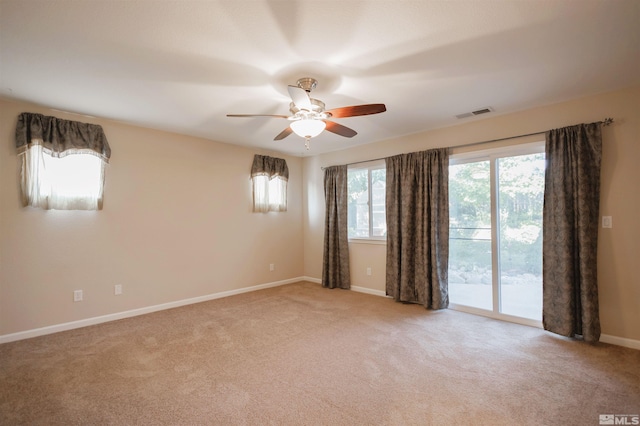 carpeted empty room featuring ceiling fan