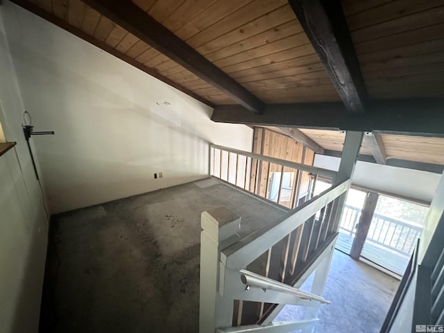 interior space with wood ceiling, beam ceiling, and concrete floors