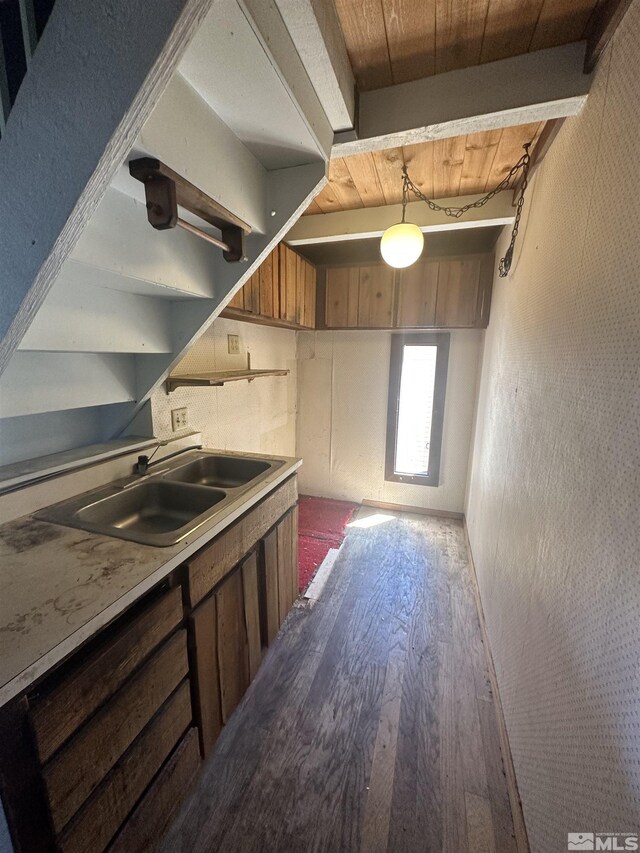 kitchen with sink, wooden ceiling, pendant lighting, and hardwood / wood-style floors