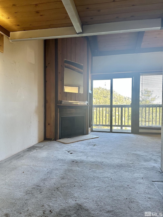 unfurnished living room featuring wooden ceiling and beam ceiling