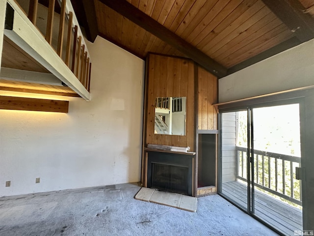 unfurnished living room with lofted ceiling with beams, a fireplace, and wood ceiling