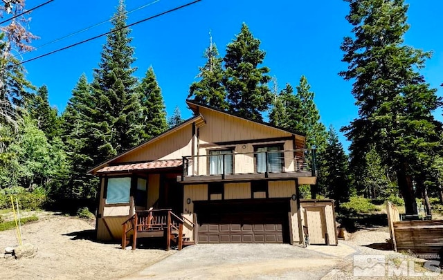 view of front of home with a balcony and a garage