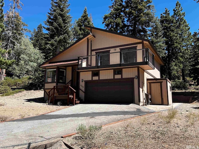 view of front of property with a garage and a balcony