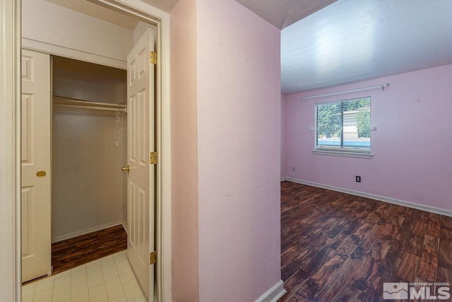 hall featuring light tile patterned floors