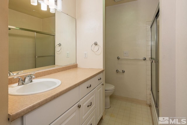 bathroom featuring tile patterned floors, vanity, and toilet