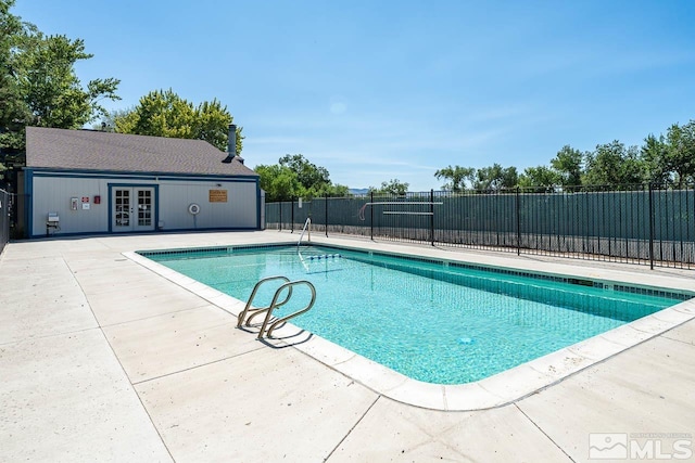 view of pool featuring a patio area and french doors