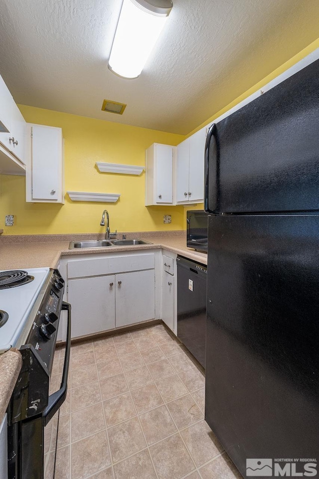 kitchen with white cabinets, light tile patterned floors, sink, a textured ceiling, and black appliances