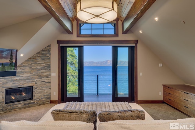 bedroom with a fireplace, carpet floors, vaulted ceiling with beams, and a water and mountain view