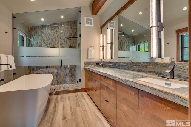 bathroom featuring dual vanity, an enclosed shower, and a healthy amount of sunlight