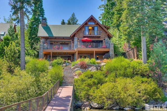 rear view of property featuring a balcony