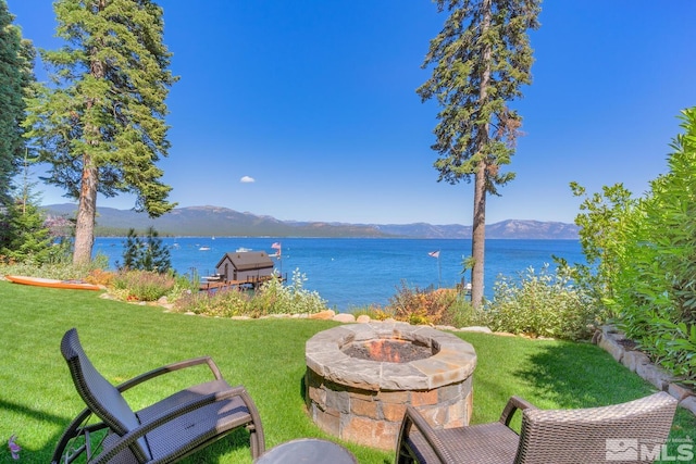 exterior space with an outdoor fire pit and a mountain view