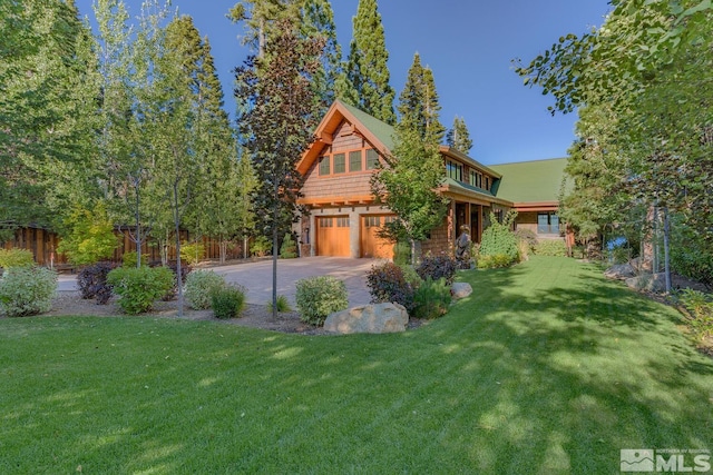 view of front of house featuring a garage and a front lawn