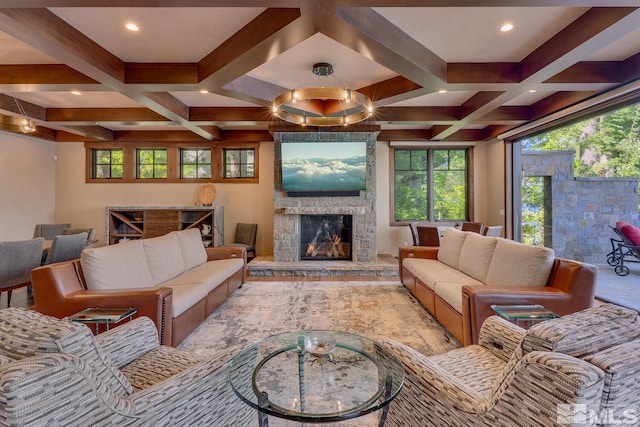 living room with a stone fireplace, beamed ceiling, and coffered ceiling