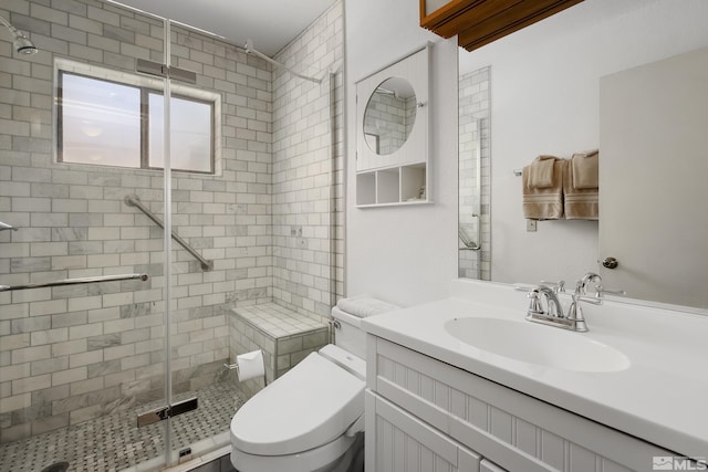 bathroom with walk in shower, vanity, and toilet