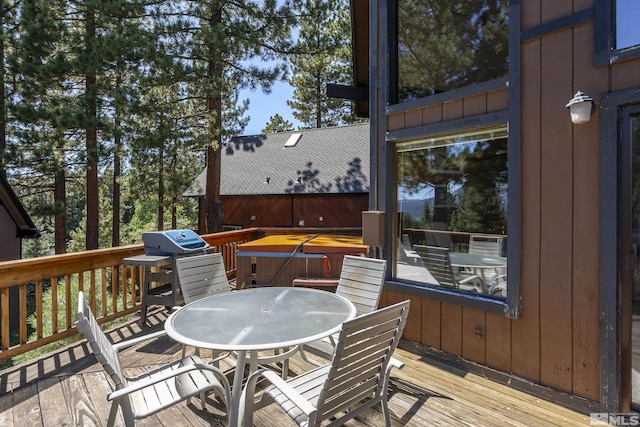 wooden deck with a jacuzzi