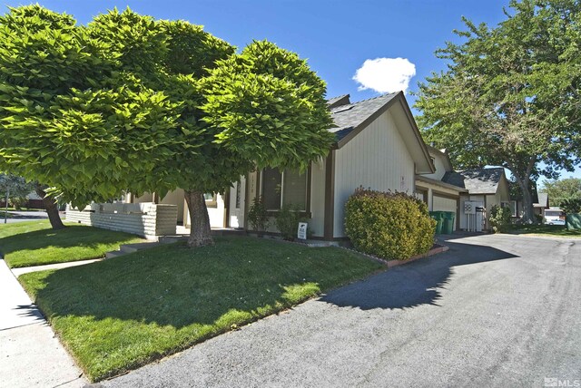 obstructed view of property with a front lawn