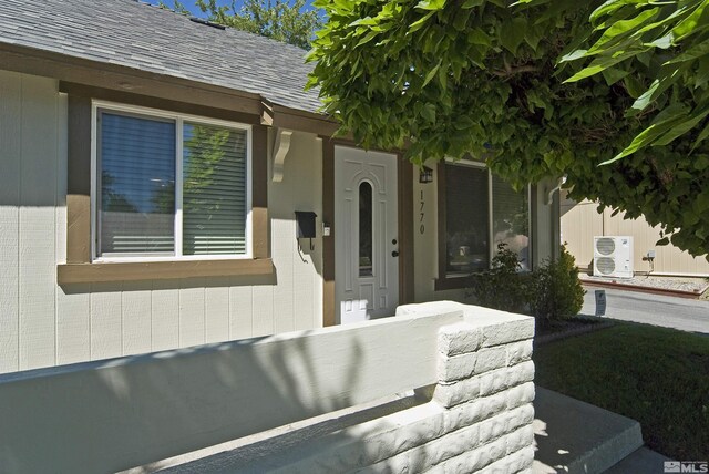 entrance to property featuring cooling unit