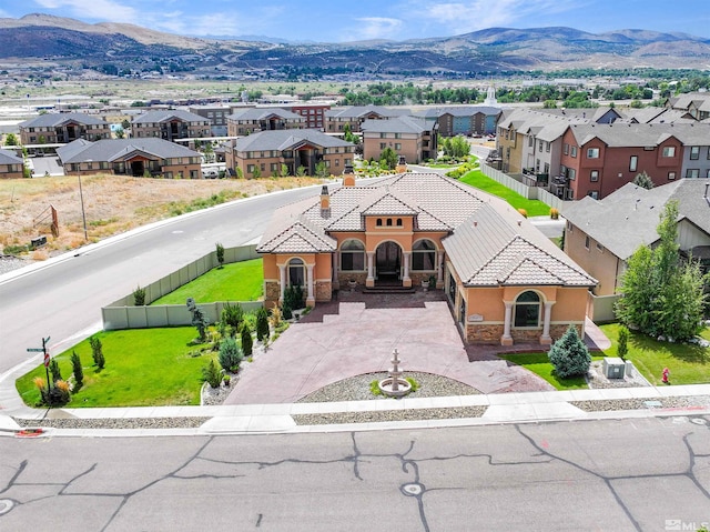 view of front facade with a mountain view and a front yard