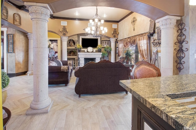 living room featuring crown molding, ornate columns, an inviting chandelier, and light parquet floors