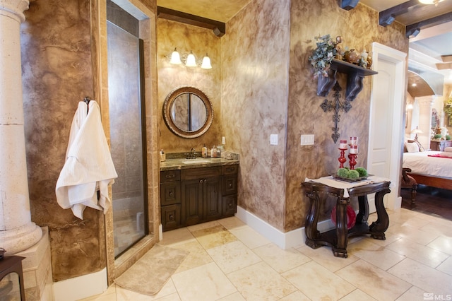 bathroom featuring beam ceiling, a shower with shower door, tile patterned flooring, vanity, and decorative columns